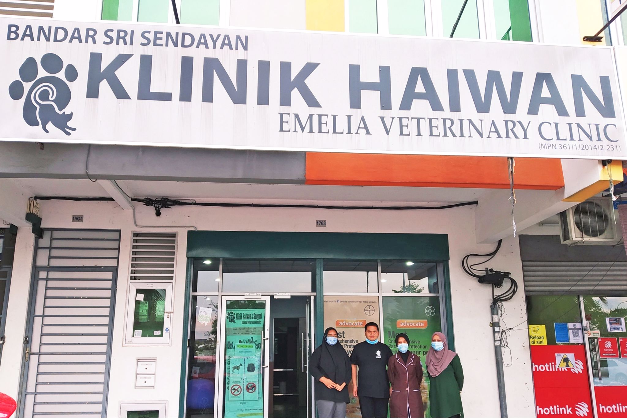 Dr. Emelia and the team behind Emelia Veterinary Clinic posing for a photo at the shopfront.  