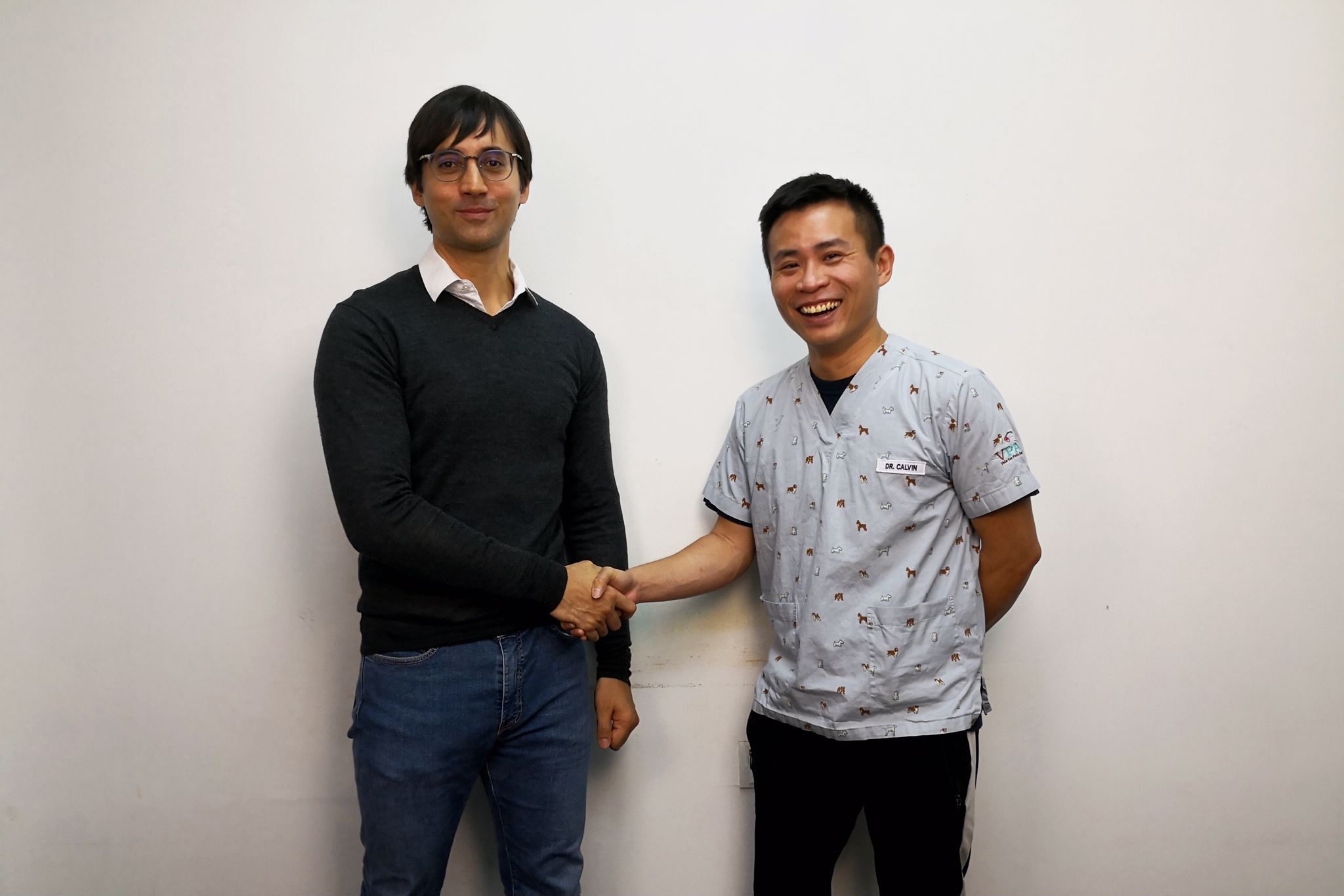 Karl and Dr. Calvin in a friendly handshake during the photo session.