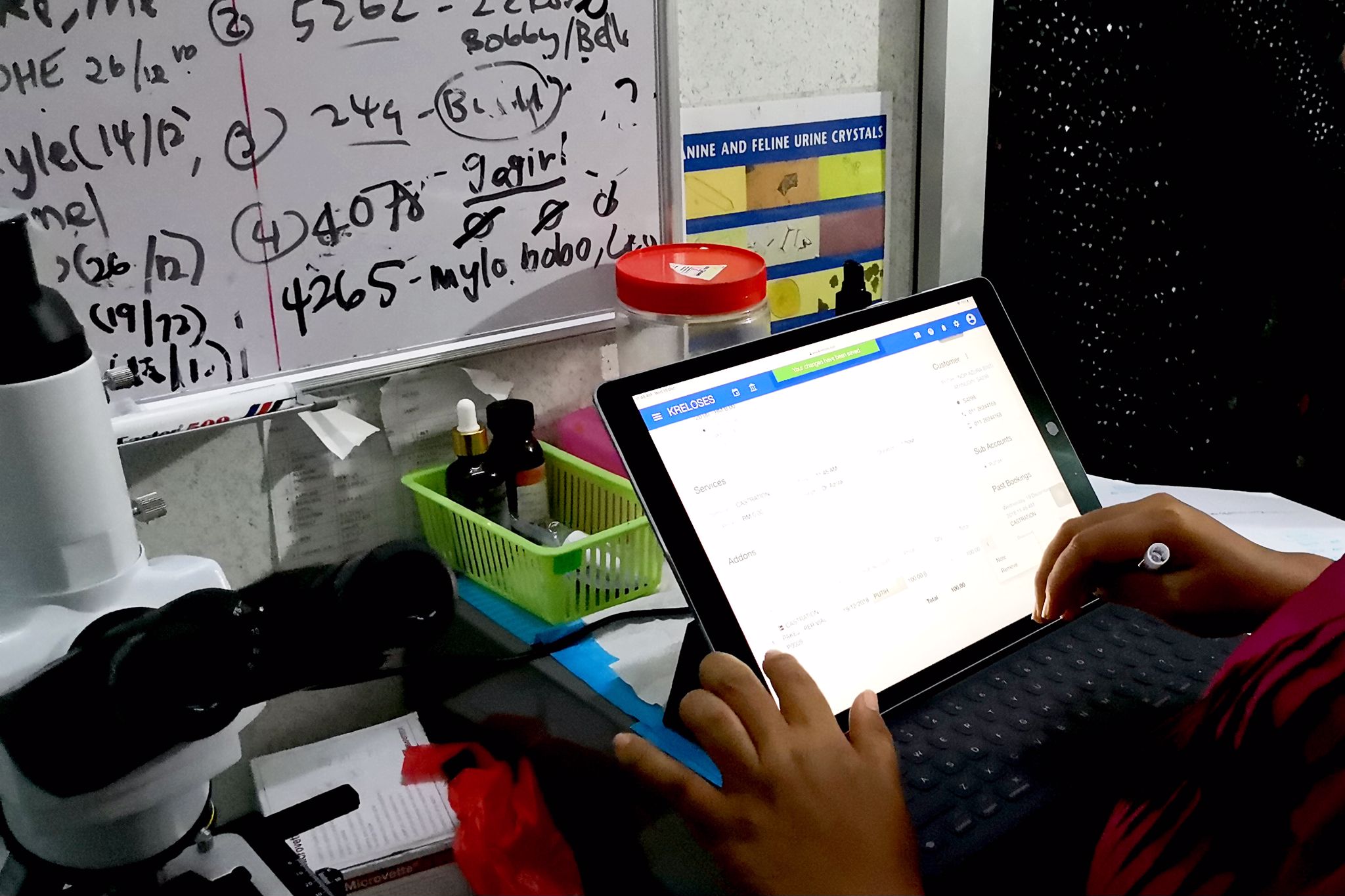 A veterinarian is jotting down consultation notes and prescribing medication to the pet from her previous service. A mobile-friendly software like Kreloses helps you simplify your operations process and provide you with ample convenience.